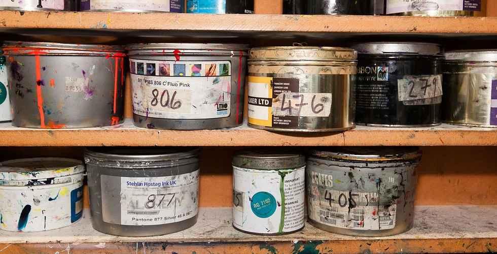 old paint cans on shelf